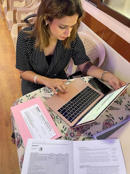 A teacher prepares for a communication skills exam session. We meticulously review exam requirements and student progress to provide targeted, effective coaching for every individual.