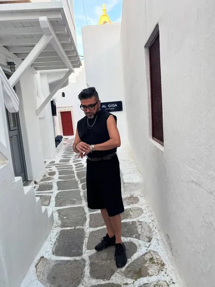 A candid moment in Mykonos, checking my watch. Even in a relaxed setting, the details matter.