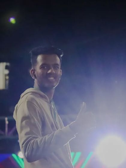 A happy moment captured on the DJ night stage, giving a thumbs-up to the camera.