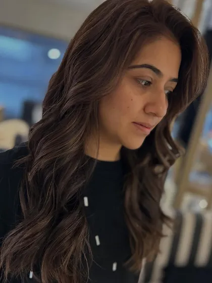 A side profile of the mocha brown hair with face-framing layers. The soft waves enhance the color and the beautiful shape of the cut.