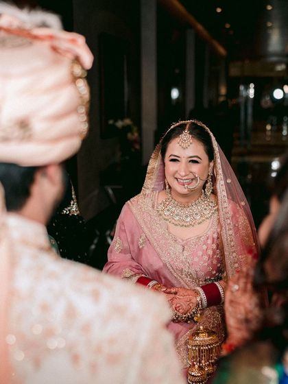 The moment the groom sees the bride. Her radiant smile is the centerpiece of this beautiful, candid shot.
