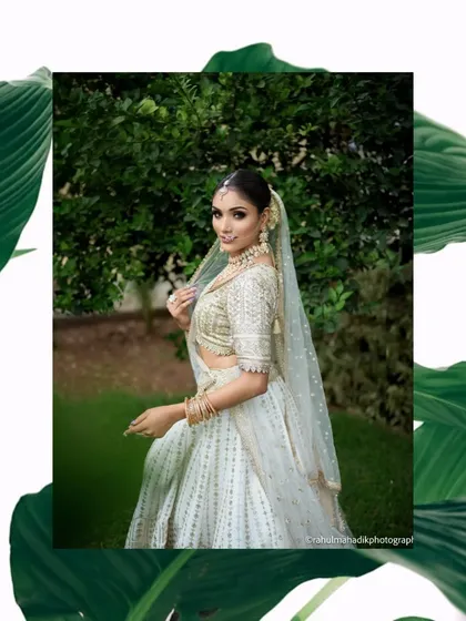 An artistic presentation of the same bridal portrait, framed by tropical leaves. This creative edit adds a modern, graphic element to the beautiful, traditional image.