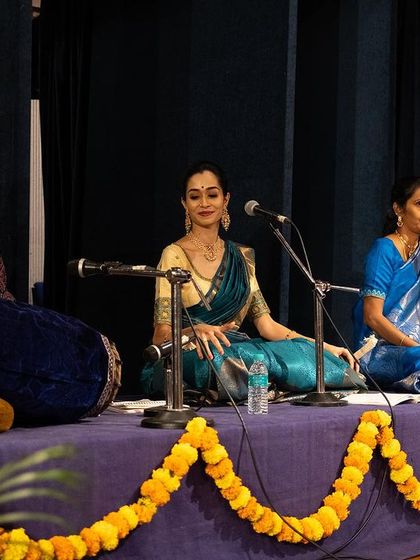 A beautiful moment on stage with the all-women's ensemble for my student's debut. I am seated in the center, conducting the Nattuvangam for the performance.