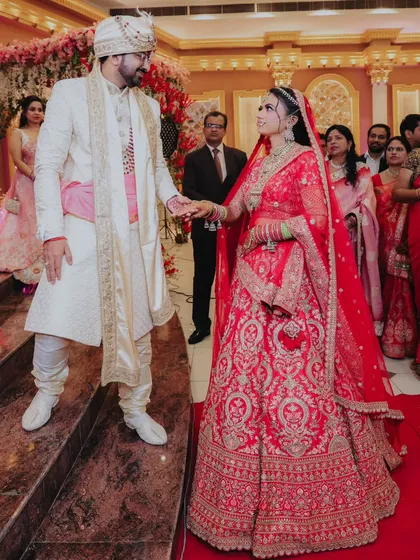 The groom helping his bride onto the stage. It's these small, chivalrous moments that add to the story of the day.