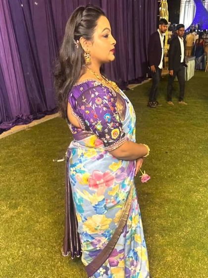 A side profile of Dr. Pavani Reddy's floral saree, showcasing the beautiful drape and the custom embroidered blouse.