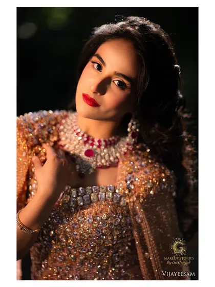 Channeling timeless Hollywood glamour for this stunning reception look. The classic red lip, soft waves, and glowing skin come together to create an aura of sophistication and elegance, perfect for a bride who wants a touch of old-world charm.