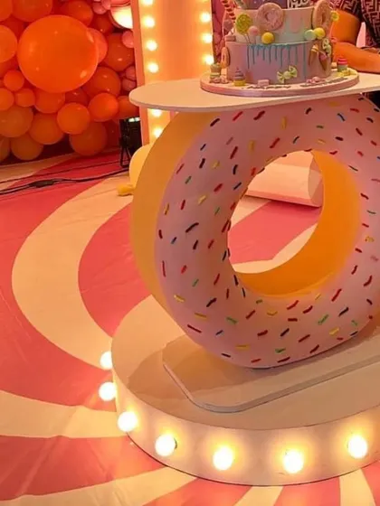 A close-up of our donut-themed LED cake table, available for rent. It's a unique and eye-catching piece that elevates any dessert or candy-themed party.