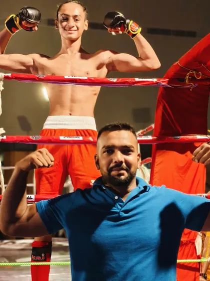 Posing with my champion. We are both flexing because we know the hard work it took to get here.