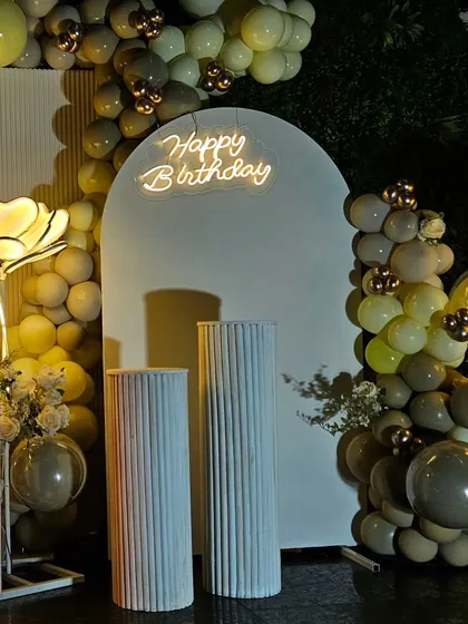 A close-up on the clean, modern aesthetic of the white arched panel and 'Happy Birthday' neon sign, perfect for a contemporary adult party.