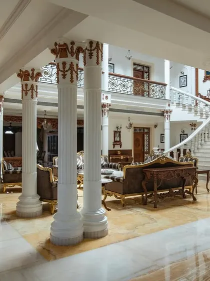 The view from the side of the living area, showing the intricate details on the columns and the seamless flow of the space.