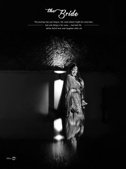 A poetic black and white portrait of the bride. The reflection on the floor and the dramatic lighting create a very artistic and memorable image.