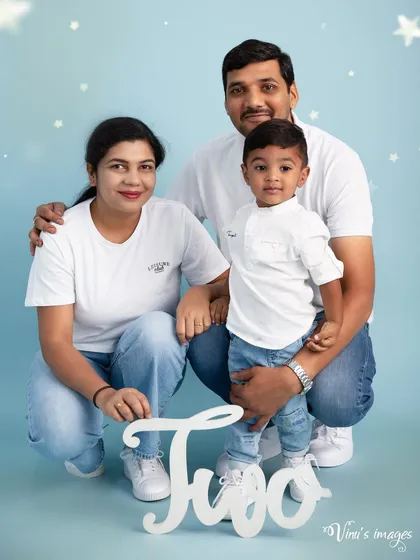 Two years old and a family celebration. This family portrait features the parents and their two-year-old son in matching white shirts and jeans for his milestone session.