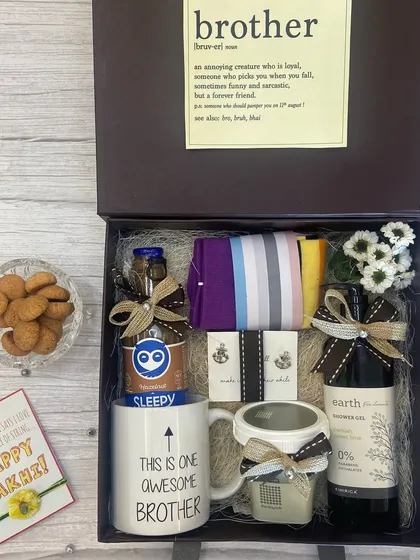 For the brother who deserves it all. This gift box features a quirky "This is one awesome brother" mug, shower gel, a scented candle, and snacks, complete with a heartfelt Rakhi card.