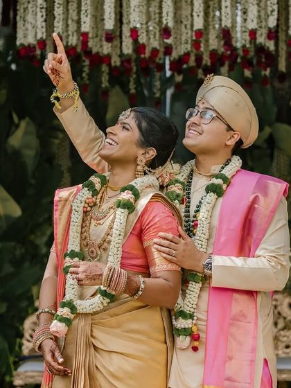The couple looks up towards the sky, a candid moment of shared wonder during their wedding ceremony.