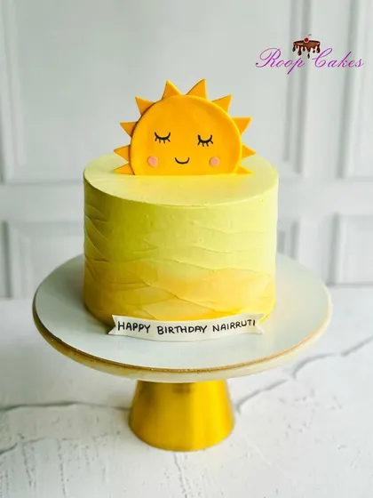 Hello Sunshine. A simple and cheerful cake with a cute smiling sun topper, perfect for brightening up any birthday.