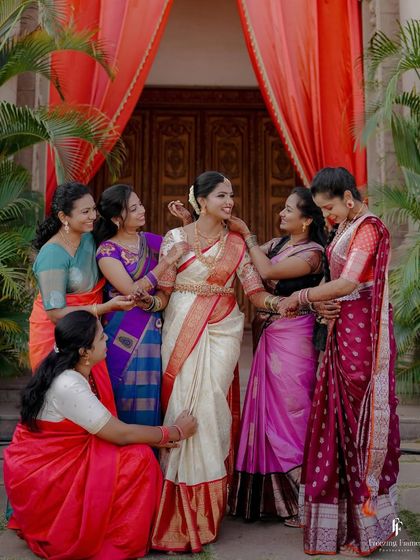 The bride surrounded by her family and friends, all helping her get ready and sharing in her happiness.