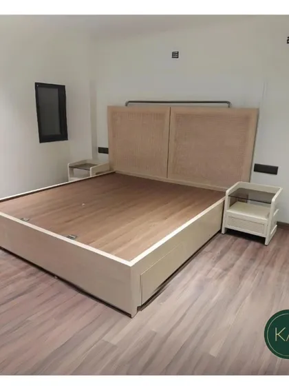 A minimalist bed with a woven cane headboard, paired with matching nightstands. This design brings a natural, airy feel to the bedroom, perfect for creating a calm and relaxed environment.