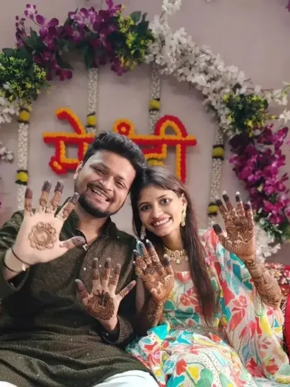 A happy couple showing off their mehandi. I also provide simple, elegant designs for grooms and guests.