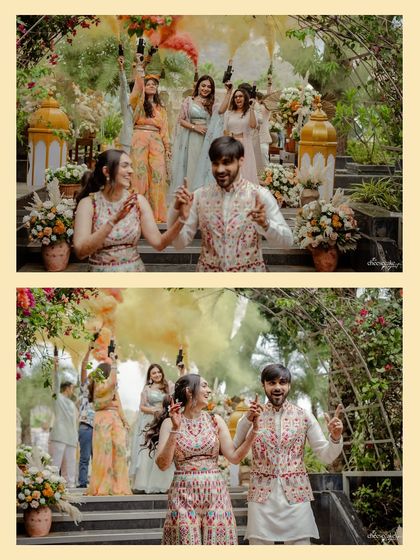 A fun, energetic shot of the couple dancing during their entry, with friends setting off color smoke in the background.