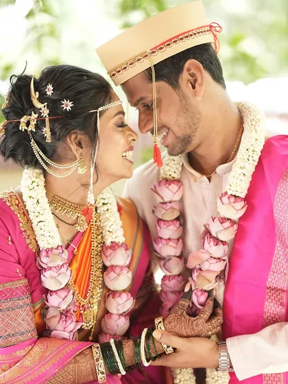 A romantic close-up of the couple. The bride's hairstyle is adorned with traditional accessories that complement her look.