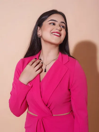 A bright and happy shot. The hot pink dress is paired with a classic red lip and clean, defined eyes, creating a bold and confident look.
