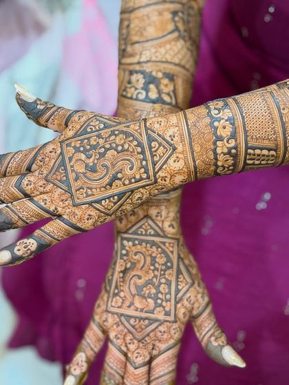 A close-up of a geometric bridal design. The sharp lines and repeating patterns create a modern yet traditional feel.