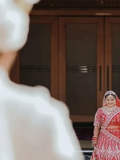 The first look. A powerful moment captured from the groom's perspective as he sees his bride in her wedding dress for the first time.