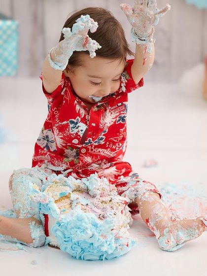 This is what a successful cake smash looks like. We let babies be babies, capturing all the messy, happy, and hilarious moments as they dive into their cake.