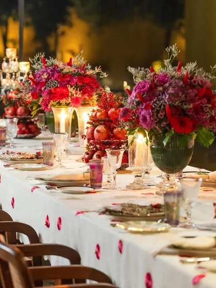 A tablescape should be a feast for the eyes. For this festive dinner, I used rich scarlet and burgundy tones, pomegranates, and glowing candles to create a warm, romantic, and luxurious atmosphere that invites guests to linger.