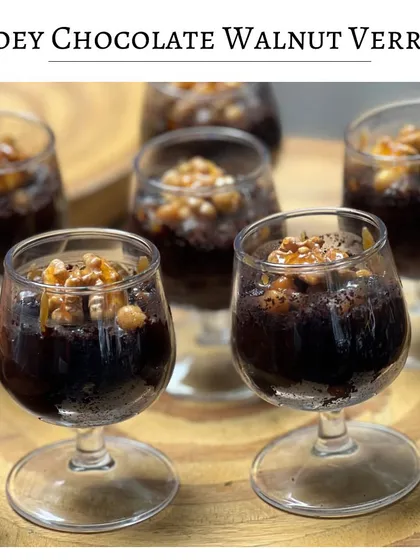 A Gooey Chocolate Walnut Verrine. This dessert features rich, dark chocolate cake layered with crunchy, caramelized walnuts, served in an elegant glass.