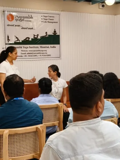 An instructor provides guidance during a corporate wellness session. We ensure that each participant understands the movements and can practice safely, even in an office setting with limited space.