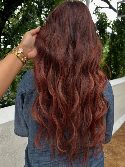 Holiday hair with a twist. This gorgeous reddish-copper color is perfect for making a statement on your next vacay. It’s warm, vibrant, and full of life.