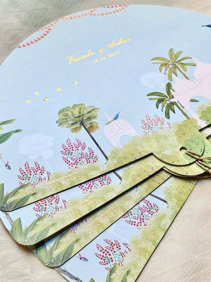 The back of the fan-shaped programs, featuring a beautiful illustration of the Arizona desert landscape with whimsical palace details.