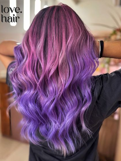 Cotton candy dreams. This look features a beautiful colour melt from a soft pink at the roots to a dreamy lavender purple at the ends, all blended seamlessly.