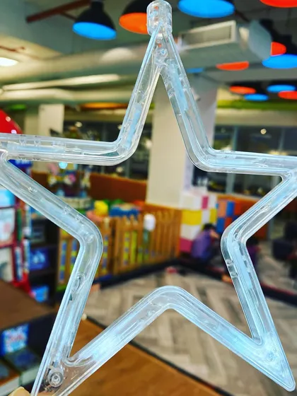 Getting ready for a festive December. This close up shot of a clear, star shaped light captures the simple, magical feeling we aim for with our holiday decorations throughout the play cafe.