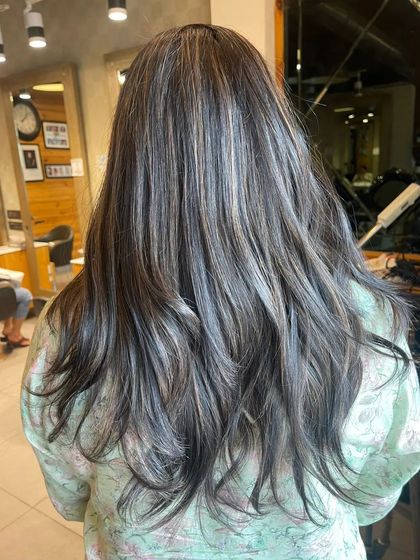 For a cooler take on highlights, we created this ashy and silver-toned look. It's a modern and chic way to go lighter.