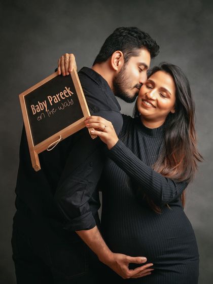 A sweet announcement shot with a chalkboard sign. This is a fun way to personalize your studio maternity photos.