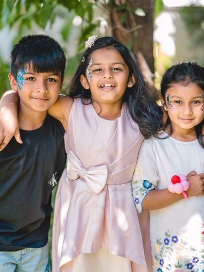 The joy of friendship and celebration. This candid shot of children at a birthday party, complete with face paint and smiles, captures the fun energy of the day.