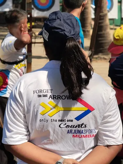 An official wearing our club shirt with the motto: "Forget the last arrow, only the next one counts." This mindset is key in archery.