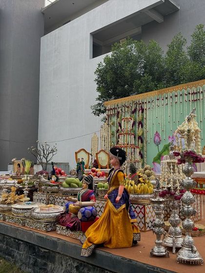 A side view of the outdoor lotus-themed stage, showing the extensive offering table.