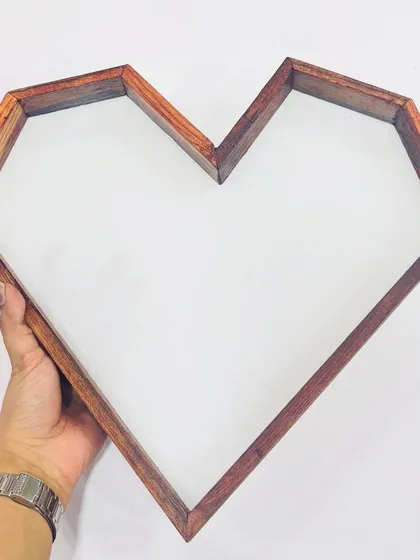 Here is our heart-shaped teakwood frame, held to show its depth and quality. It's an ideal choice for artists looking to create memorable and heartfelt resin keepsakes.
