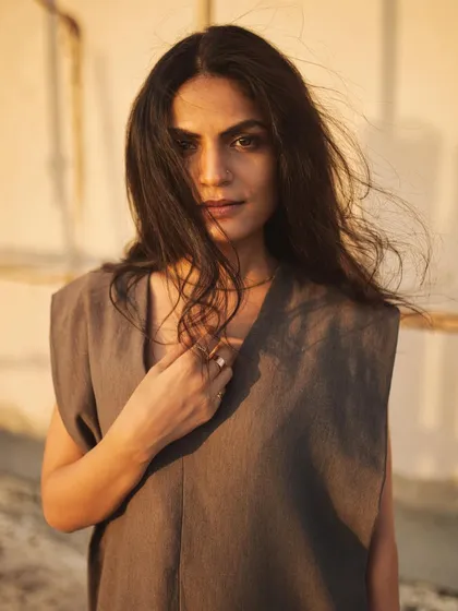 A simple, direct portrait where the warm sunset light and gentle breeze create a beautiful, natural look.