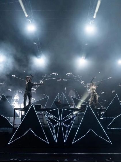 Alan Walker and his co-performer on their futuristic, geometric stage setup during the Walker World tour.
