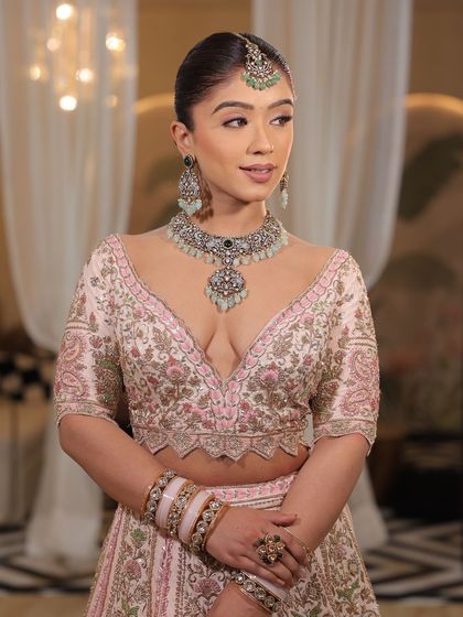 A detailed shot of the blouse of the pink bridal lehenga. The craftsmanship and the unique design make it a true work of art.