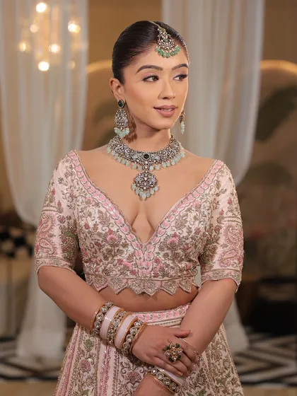 A detailed shot of the blouse of the pink bridal lehenga. The craftsmanship and the unique design make it a true work of art.