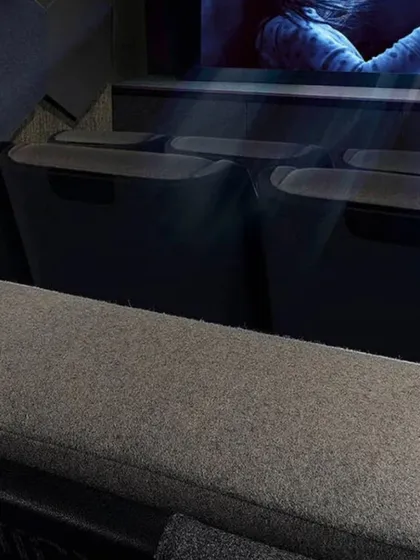 A closer look at the design elements of our "Entertainment Reimagined" concept. Notice the textured wall panels for acoustic treatment, the precise placement of recessed ceiling lights, and the comfortable, fabric-upholstered cinema seats.