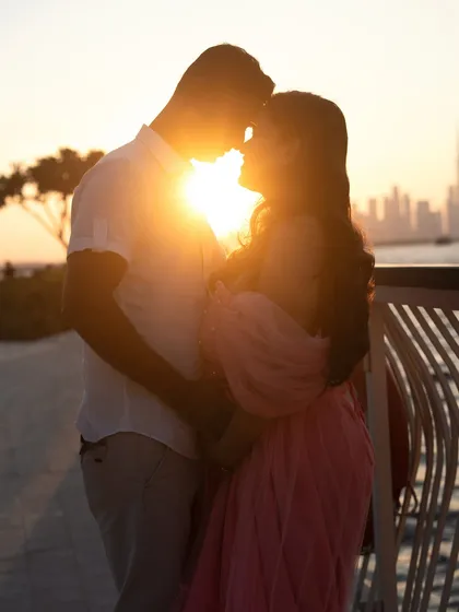 There is nothing more romantic than a silhouette against a sunset. This golden hour shot in Dubai captures the quiet, intimate connection between partners as they wait for their new arrival, with the city skyline painting a perfect backdrop.