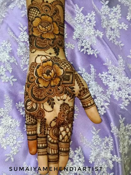 A simple and sweet floral design on the hand. This is perfect for someone who wants a touch of henna without full coverage.