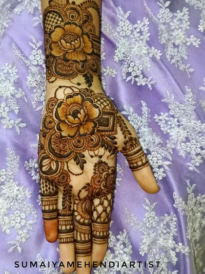 A beautiful floral henna design with large, detailed flowers.