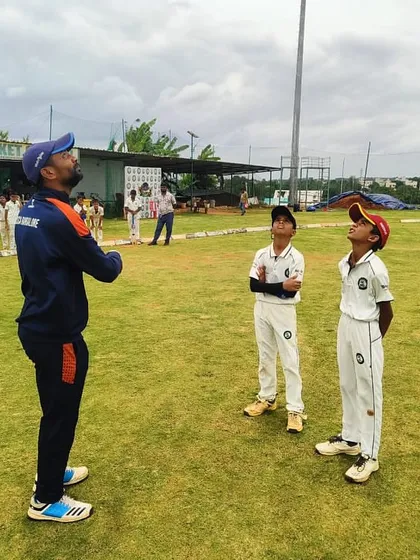 A coach demonstrating a high-catch technique to our U-12 players. Practical, on-field coaching is central to our methodology.
